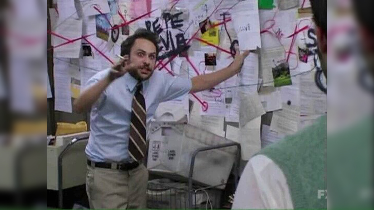 Charlie Day at his string-covered conspiracy board, overwhelmed by too many pinned notes